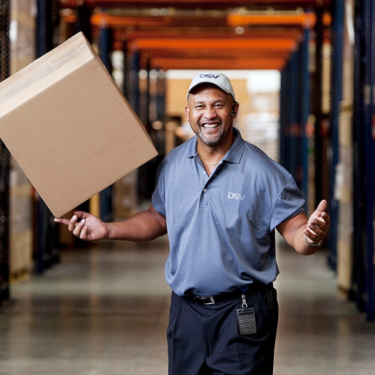 Person in einem Warenlager mit Paket